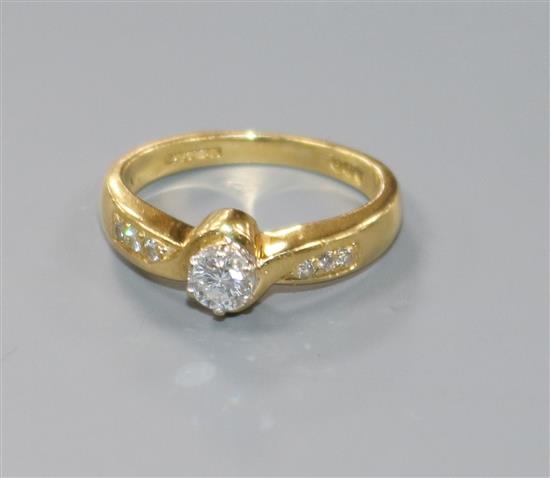 A modern 18ct gold and single stone diamond ring, with diamond set shoulders, size H.